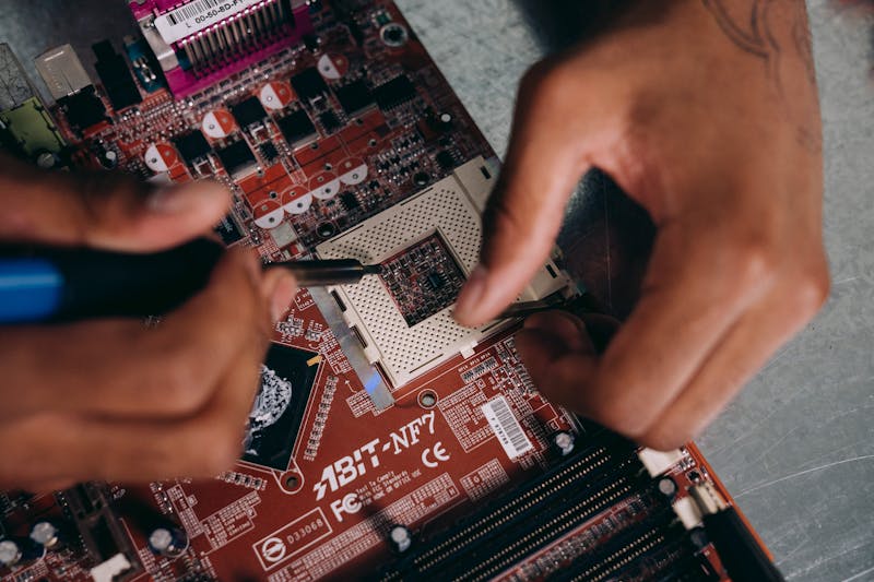 Technician repairing computer motherboard